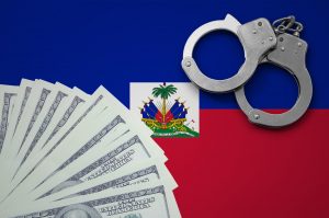 Haiti flag with handcuffs and a bundle of dollars
