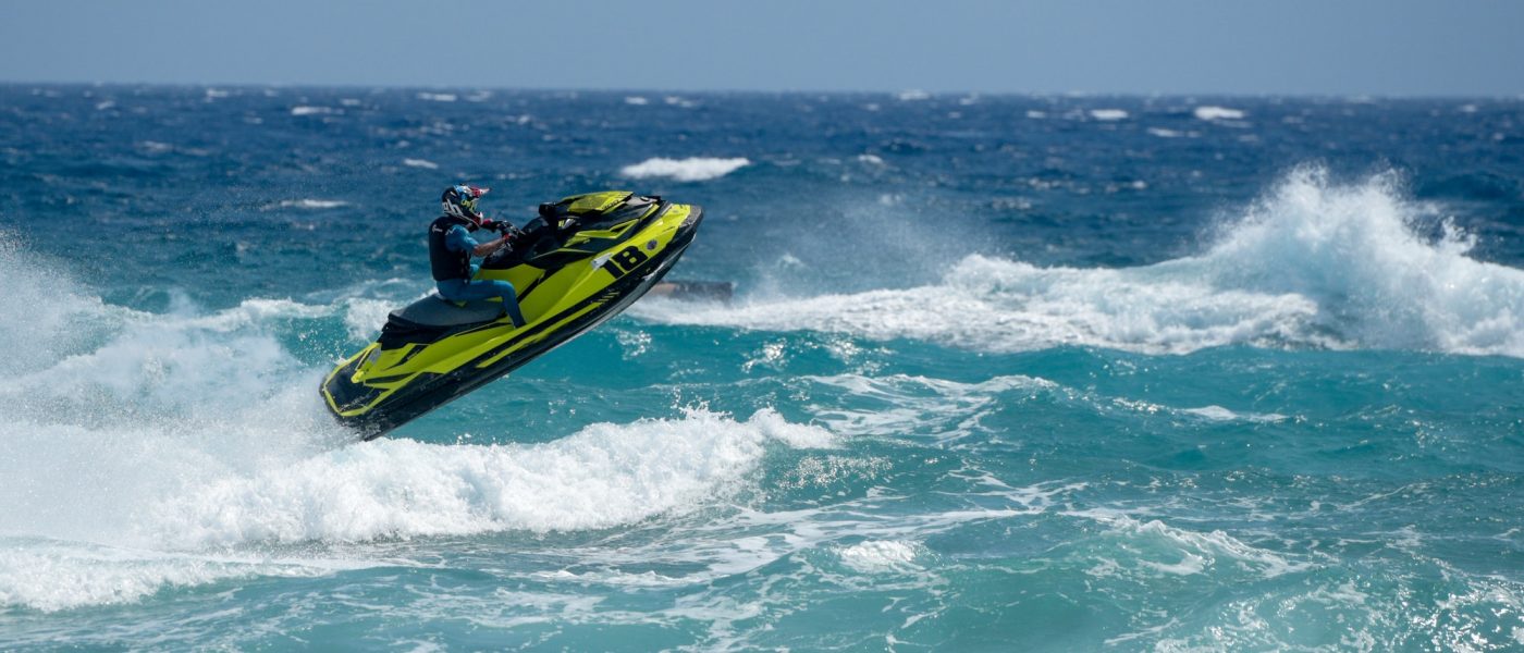 Man on water scooter, Jet ski against sea waves