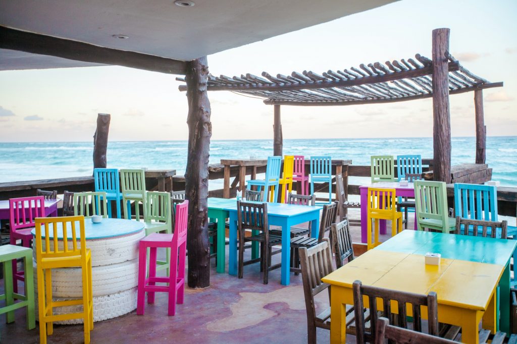Bright colored bar-restaurant on the white sandy beach in Tulum