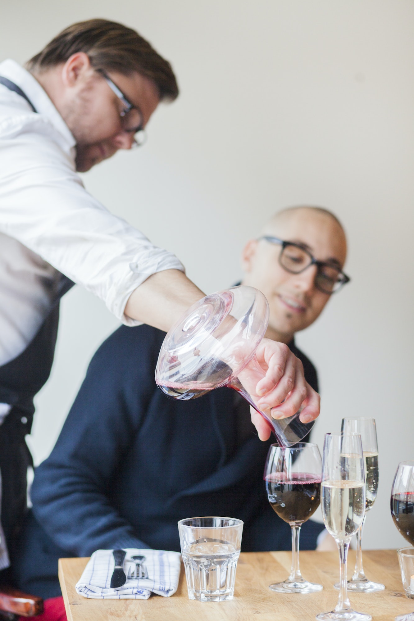 Chef serving red wine to customer in restaurant