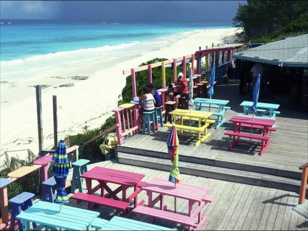Restaurant in the Bahamas with colorful tables and chairs