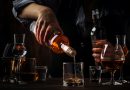 The bartender pours the dark golden rum