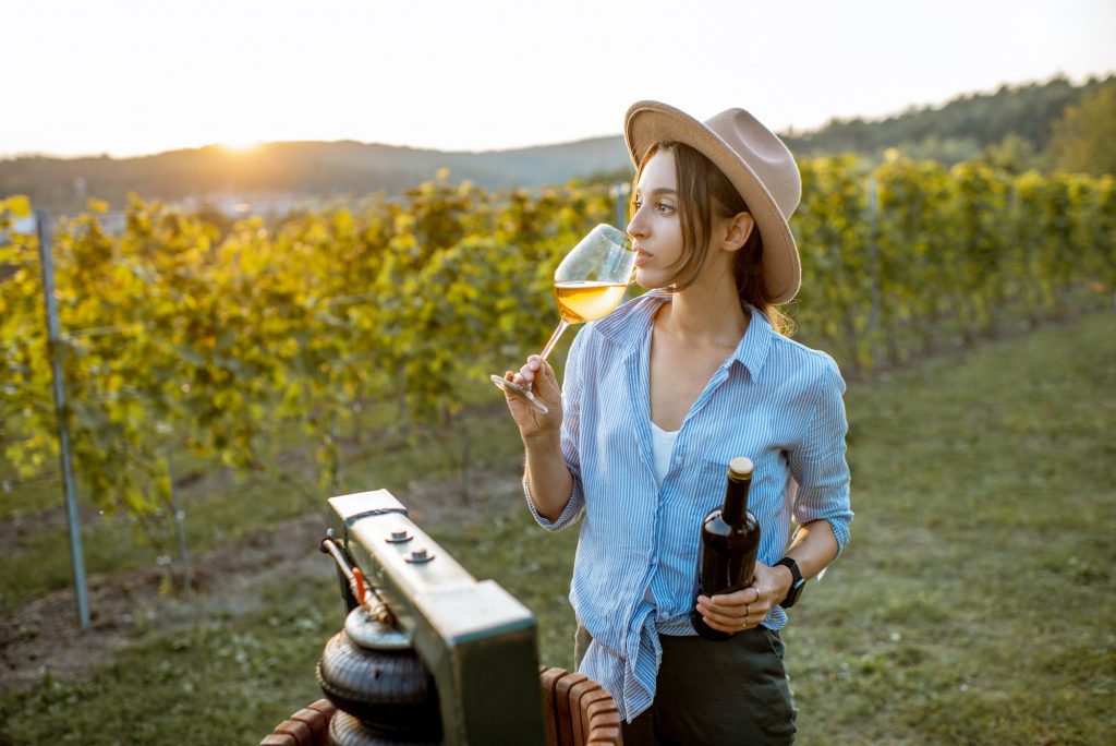 Woman tasting wine on the vineyard