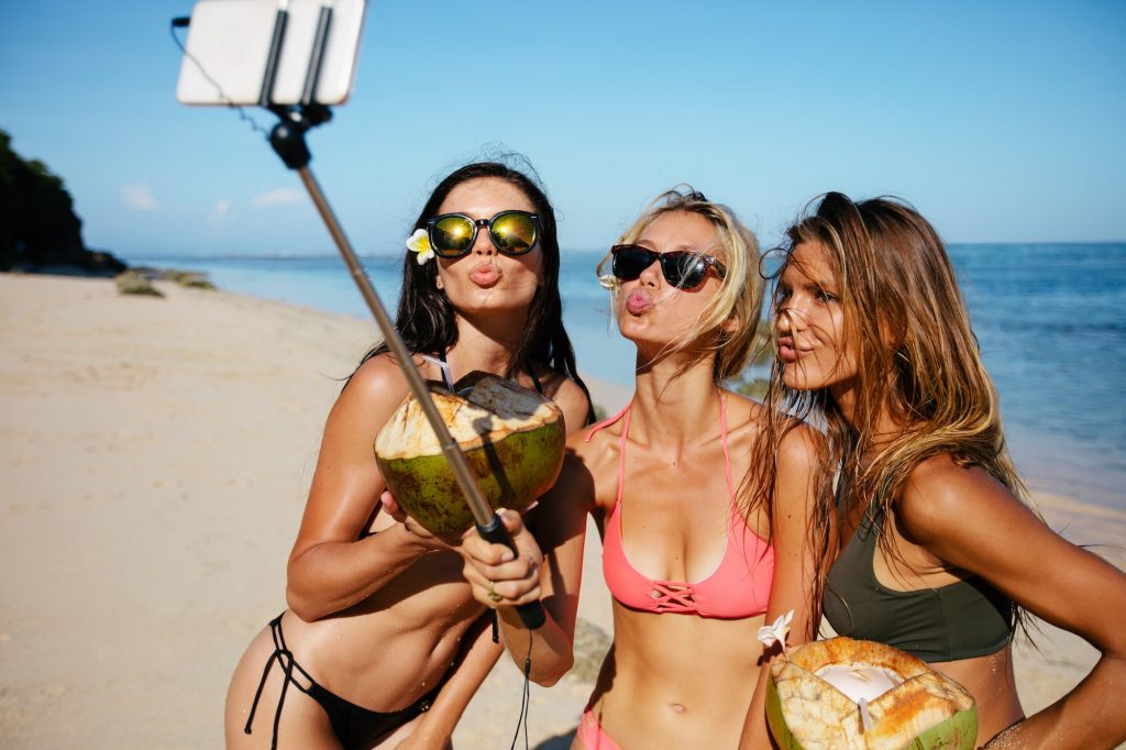Women pouting for selfie on the beach