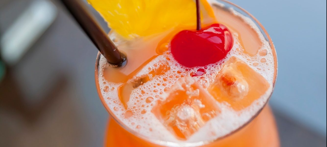 Fruity refreshing cocktail with cherry on top, view from above