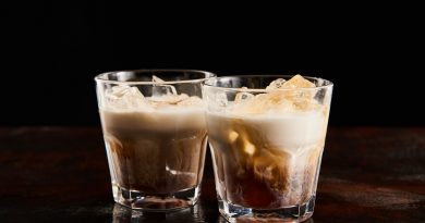 fresh white russian cocktail in glasses isolated on black