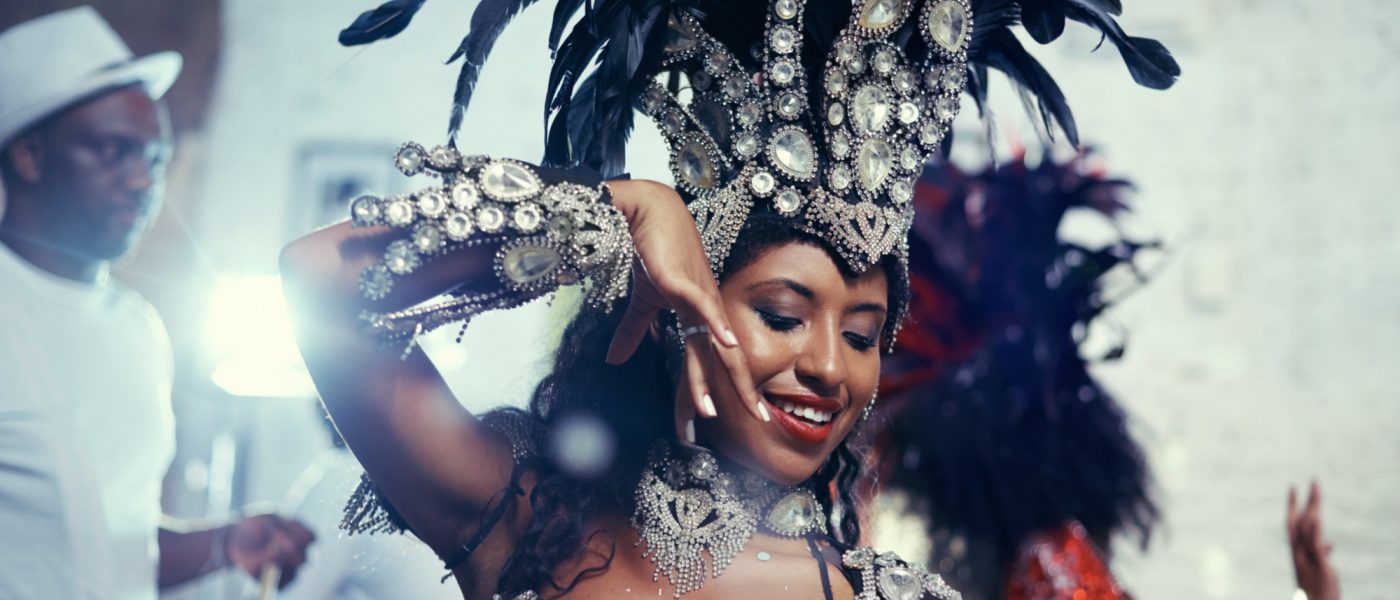 Shot of a beautiful samba dancer performing in a carnival with her band