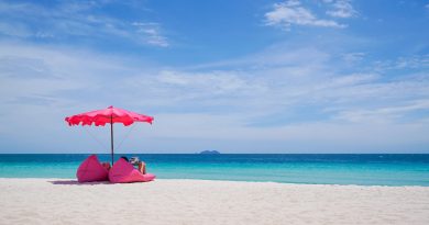 Pink parasol and seat on the tropical beach