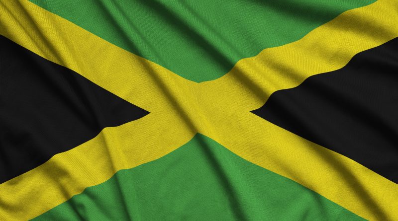 Jamaica flag is depicted on a sports cloth fabric with many folds. Sport team waving banner
