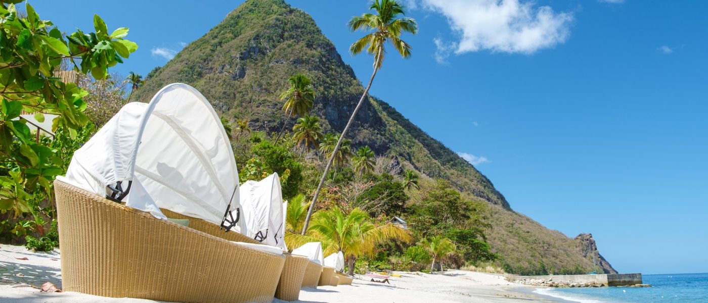 Sugar beach Saint Lucia ,white tropical beach palm trees and luxury beach chairs St Lucia Caribbean