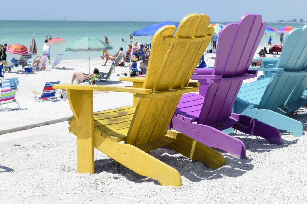 Bright, colorful Adirondack beach chairs on St. Pete Beach, Florida