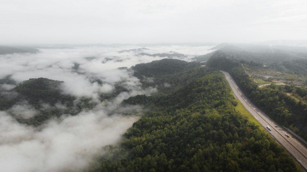 Aerial view of green mountains near a river in Tennessee on a misty morning