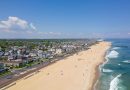 Drone shot of the Belmar Beach and coastal road and buildings on a sunny day in Belmar, New Jersey