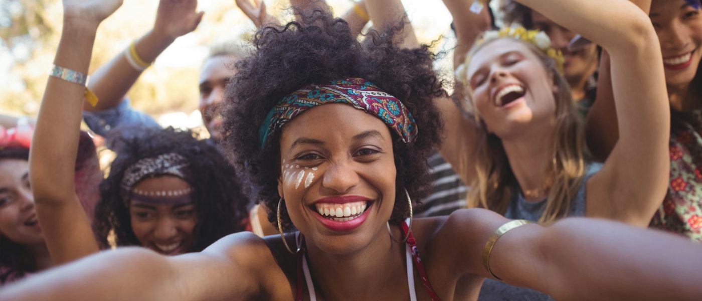 Cheerful young woman enjoying at music festival