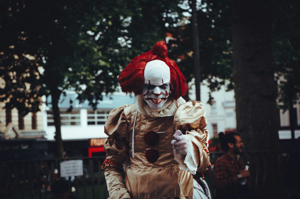 It. Costume. Clown. Close-up. Horror movie. Red color. Front view. Film. Focus on foreground.