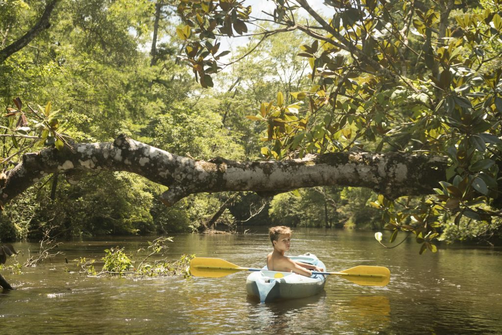 Teenage boy in kayak, Econfina Creek, Youngstown, Florida, USA