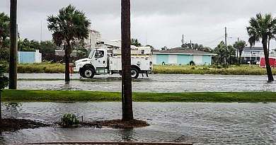 Transportation and logistics after hurricane damage on water logged roads at the beach community.