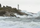 Storm Laura shows her muscles in hurricane stormy weather with lighthouse in background, big waves